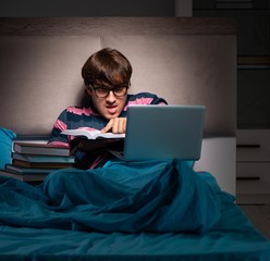 Young student preparing for exams at night at home