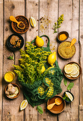Obraz na płótnie Canvas Ingredients for healthy hot drink. Lemon, ginger, honey, and turmeric in a bowls on a wooden background. Ambrosia, pollen and propolis in a bowls. Alternative medicine concept. Clean eating, detox.