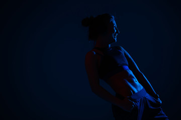 In neon blue lighting demonstrates relief external oblique abdominal muscles model on a dark blue background.