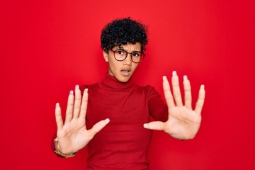 Young beautiful african american afro woman wearing turtleneck sweater and glasses doing stop...