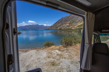 Fototapeta na wymiar Lake view from campervan. Caravan traveling concept