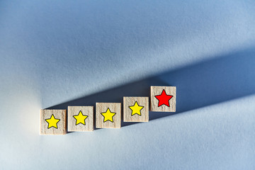 Customer experience. Rate with stars. Wooden blocks on blue background. Total satisfaction. Service...