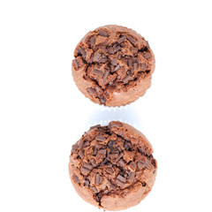 Chocolate birthday cupcakes with a cocoa frosting on top with dessert cutlery, on white background, horizontal