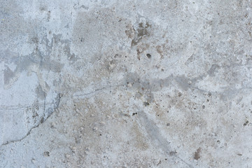 Texture background - old porous gray concrete wall with stains and cracks.