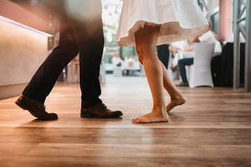 photo of legs of a couple dancing indoor