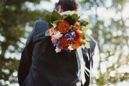 photo of a groom and a bride holding a bouquet