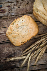 Fresh rye bread or whole grain bread on dark table background. Healthy baked bread in slices, whole homemade bread. Organic farm food. 