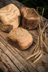 Fresh rye bread or whole grain bread on dark table background. Healthy baked bread in slices, whole homemade bread. Organic farm food. 