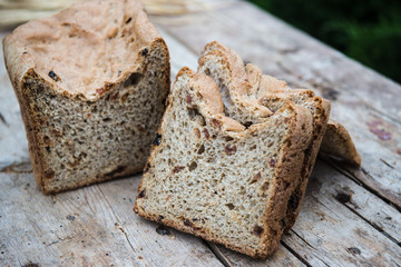Fresh rye bread or whole grain bread on dark table background. Healthy baked bread in slices, whole homemade bread. Organic farm food. 