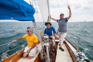 three seniors on a sailboat