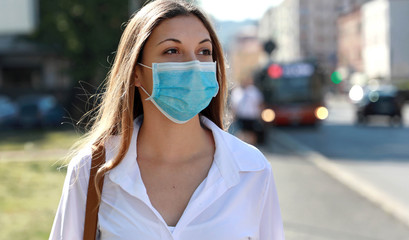 COVID-19 Pandemic Coronavirus Woman in city street wearing surgical mask protective for spreading...