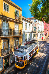 Fototapeta premium Famous vintage tram in the street of Alfama, Lisbon, Portugal