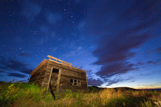 abandoned shack at night, starry sky