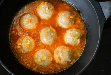 appetizing meatballs in a sauce stew in a pan. Top view