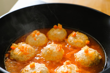 appetizing meatballs in a sauce stew in a pan. Top view