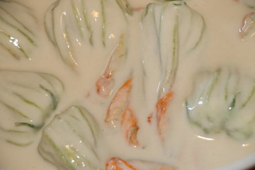 preparation of zucchini flowers in batter with mozzarella and anchovies