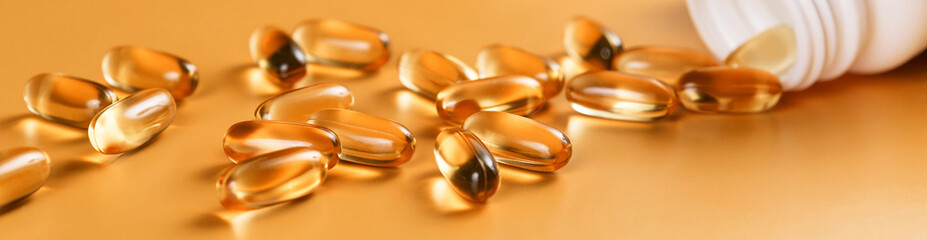 Many capsules Omega 3 on yellow background. Close up, high resolution product. Health care concept.