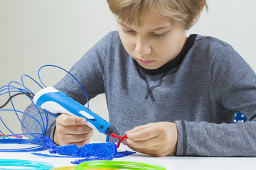 Education, creative learning, entertainment at home for kids. Focused child creating new project with 3d pen.