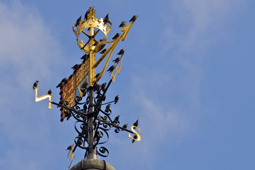 Closeup of St Edward's Crown, the Royal Standard weather vane and birds.  This sits atop the White...