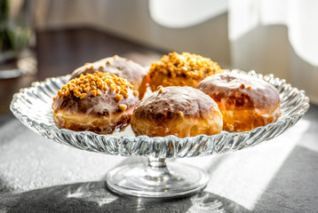 Many homemade donuts on a plate