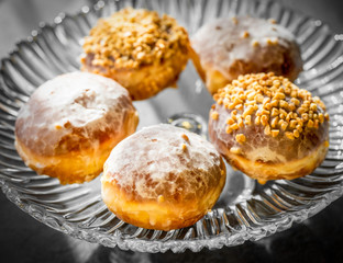Many homemade donuts on a plate