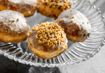 Many homemade donuts on a plate