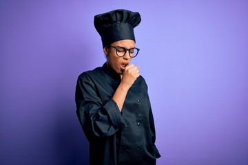 Young african american chef girl wearing cooker uniform and hat over purple background feeling unwell and coughing as symptom for cold or bronchitis. Health care concept.