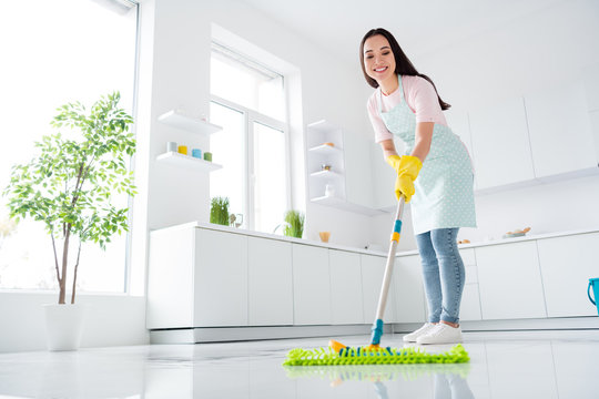 Full length body size view of her she nice attractive cheerful cheery hardworking girl making fast domestic work wiping perfect ceramic floor in modern light white interior kitchen indoors