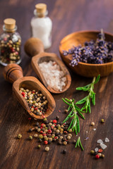 Salt, pepper with rosamary and lavender on wooden background