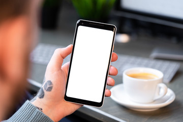 Businessman Holding Mobile Phone With Blank Screen and Drinking Coffee, Online Meeting and Conference, Copy Space. Empty Space