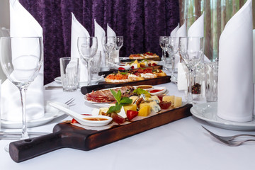 Hamburgers and French fries on a wooden tray.