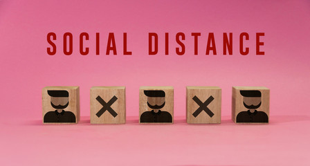 Social distance, people practice social distancing to protect from COVID-19 coronavirus. Social distancing sign with cubes apart from each other respecting correct distance. Top view. Respecting space