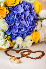 Wedding rings against the background of the bride's bouquet.