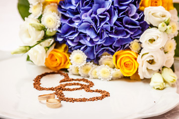 Wedding rings against the background of the bride's bouquet.