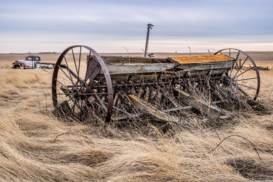 A Vintage Pioneer Seed Drill With A Classic Truck In The Background In Saskatchewan, Canada