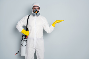 Photo of disinfectant clean public transport pandemic spray hold open arm new effective chemicals safe for house home specialist wear hazmat protective suit isolated grey color background