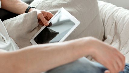 young man with a digital tablet sitting on the couch