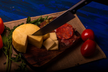Cheese with serrano ham, olives on a table for a party with friends or as an aperitif