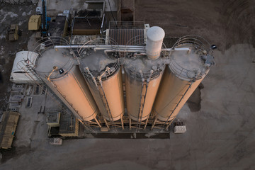 gravel pit silos in sunset with desatured colors
