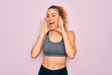 Young beautiful blonde sportswoman with blue eyes doing exercise wearing sportswear Smiling cheerful playing peek a boo with hands showing face. Surprised and exited