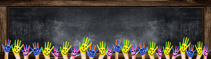 School background banner Panorama - Many brightly painted children's hands in front of a old aged...