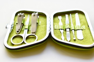 Green handbag with a set for a pedicure