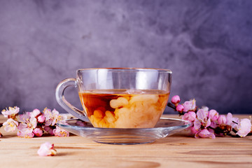 Glass cup of tea with milk. Drink for English breakfast.