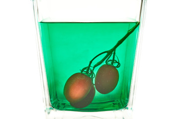 cherry tomatoes in green glass