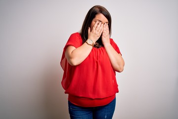 Beautiful brunette plus size woman wearing casual red t-shirt over isolated white background...