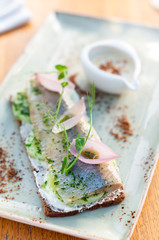 Rye Bread Sandwich Smorrebrod with Herring, Potato and Pickled Onion