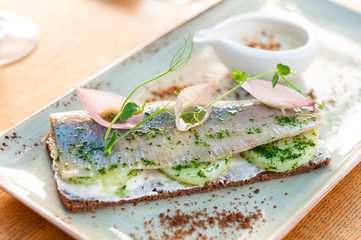 Rye Bread Sandwich Smorrebrod with Herring, Potato and Pickled Onion