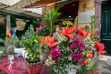 Fototapeta na wymiar Beautiful flowers and plants exposed on the street for sale. Flower shop
