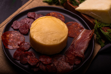 Cheese with serrano ham, olives on a table for a party with friends or as an aperitif