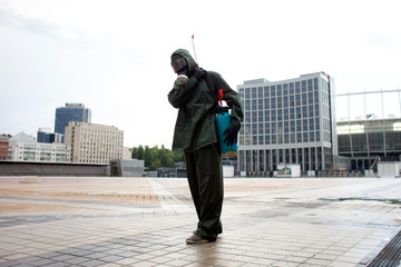 Coronavirus pandemic. disinfection service worker in a protective suit cleans the streets of the city from virus and infection with chemicals